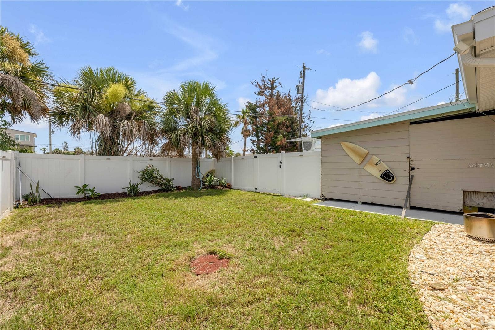 3929 S PENINSULA DRIVE, Port Orange, FL 32127 Fenced yard with lawn and detached outbuilding.