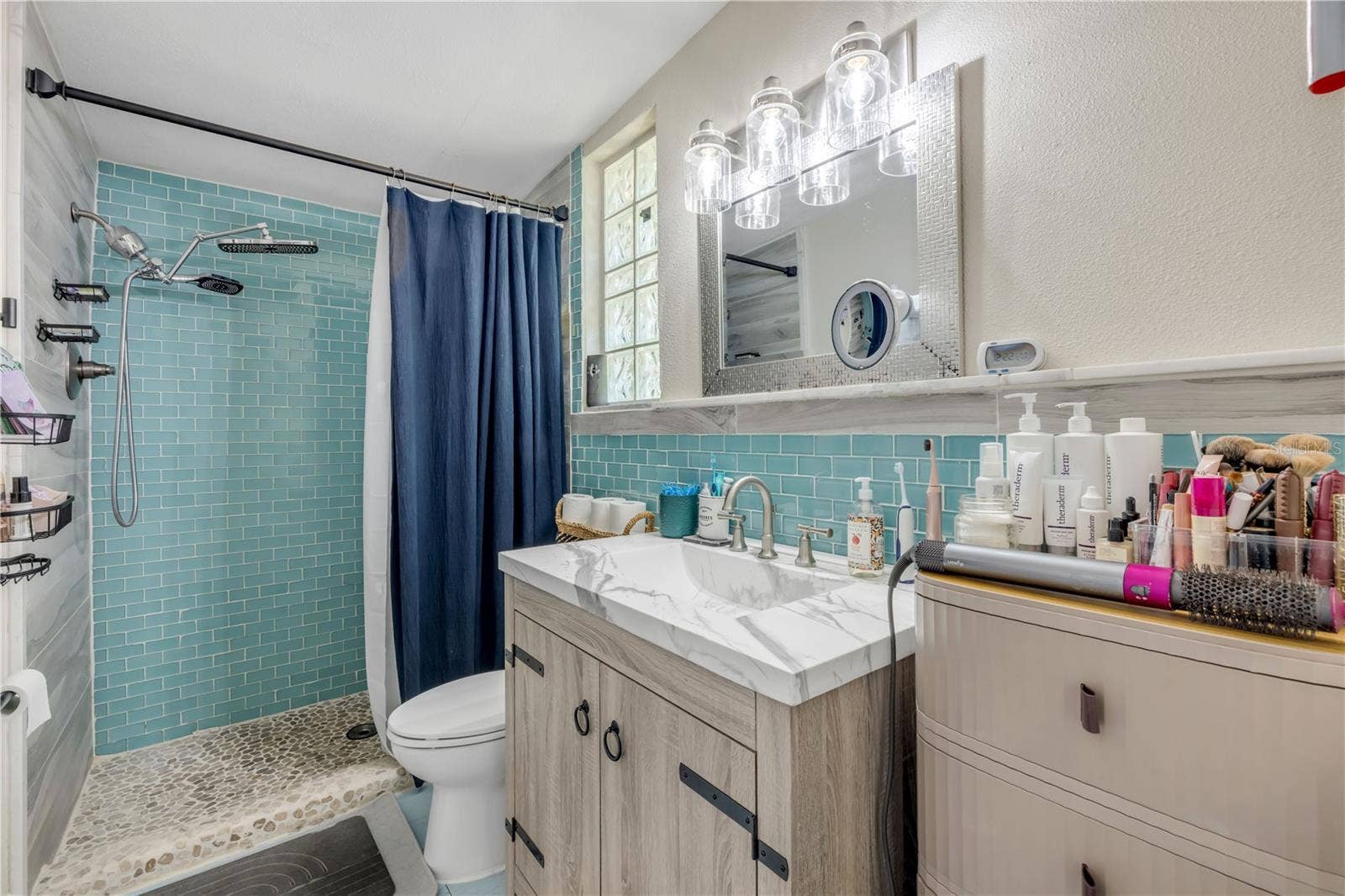 3929 S PENINSULA DRIVE, Port Orange, FL 32127 Bathroom with double-sink vanity and a glass-enclosed shower.
