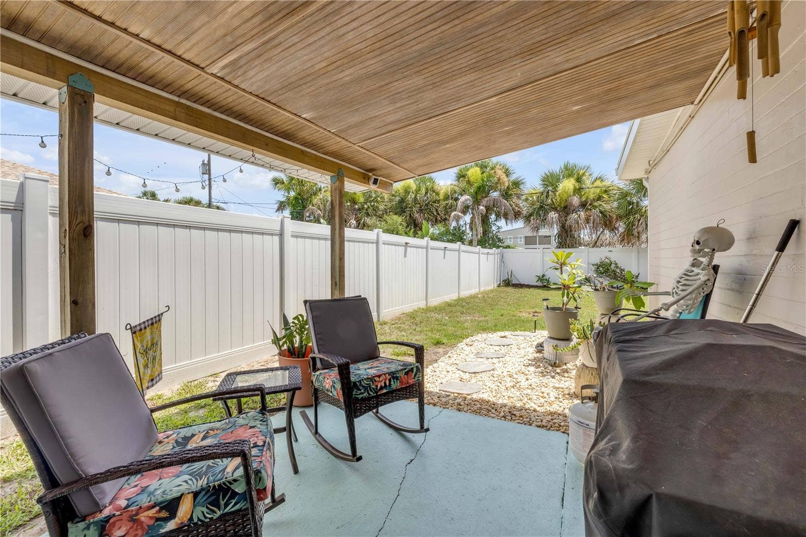 3929 S PENINSULA DRIVE, Port Orange, FL 32127 Alternate covered-patio view overlooking the fenced yard.