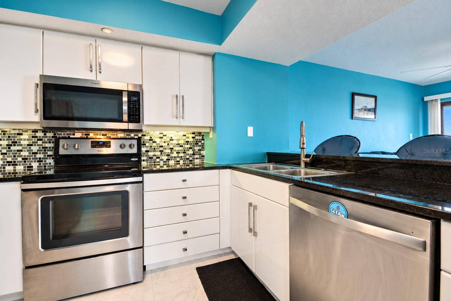 5207 S ATLANTIC AVENUE, #1126, New Smyrna Beach, FL 32169 Kitchen has granite counters and stainless appliances.