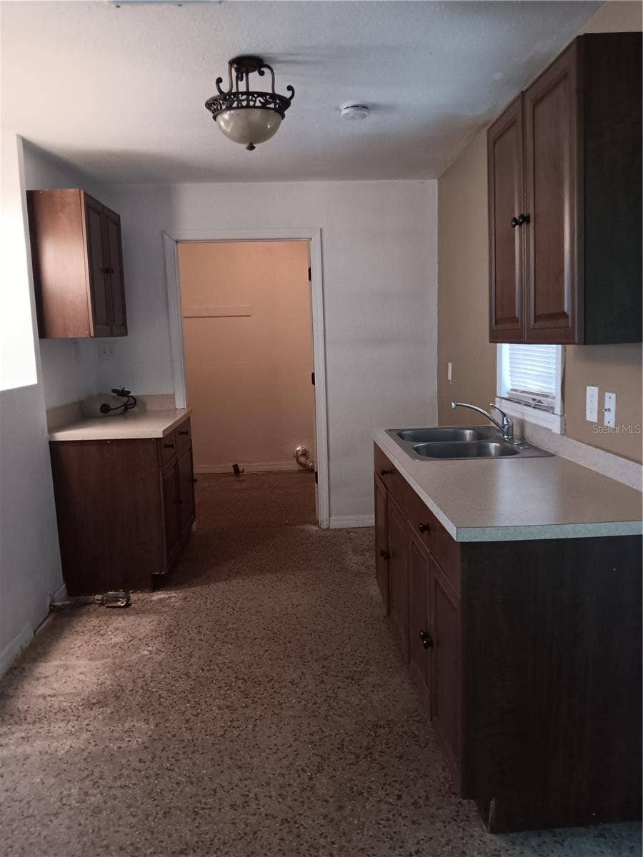 2103 MANTILLA AVENUE, Orlando, FL 32811 View of kitchen toward laundry room