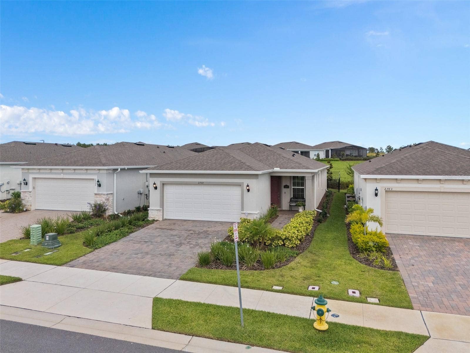 2759 PURPLE MEADOW COURT, Minneola, FL 34715 Elevated Front View. Please take note of the green space at the rear of the home.