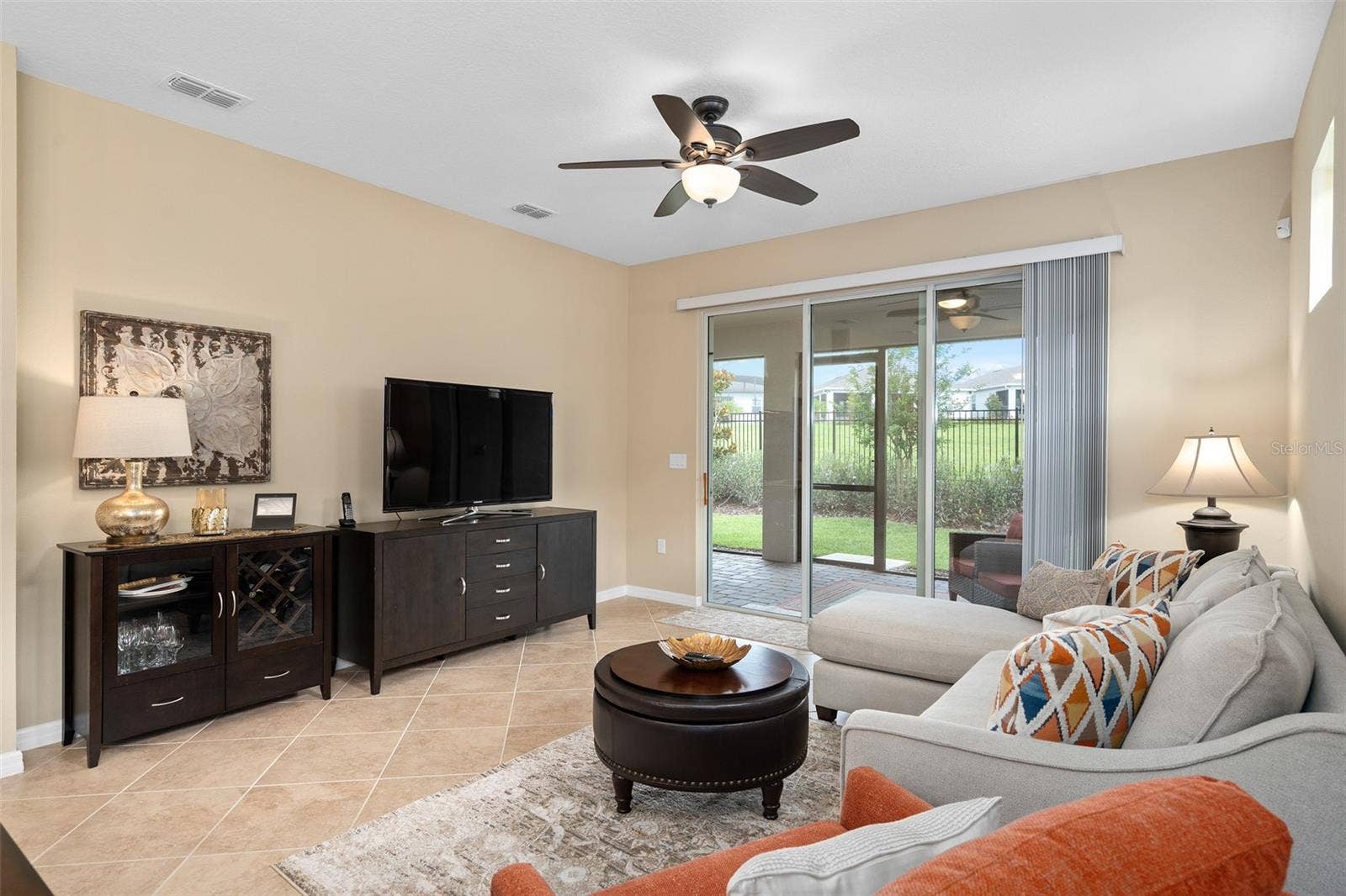 2759 PURPLE MEADOW COURT, Minneola, FL 34715 The Family Room offers a view of the Under Roof Screened Lanai with Pavers.