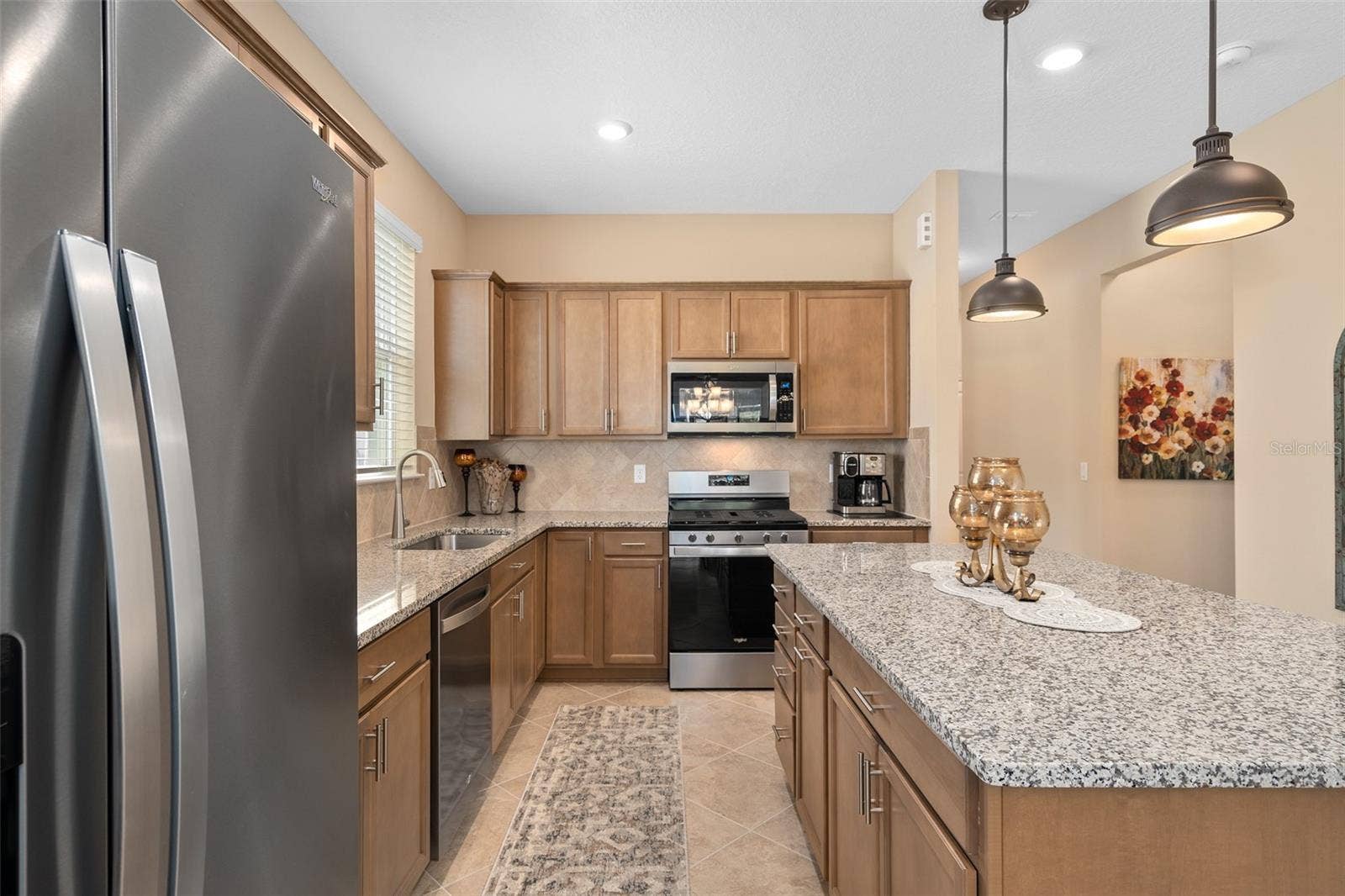 2759 PURPLE MEADOW COURT, Minneola, FL 34715 Solid Wood Cabinetry embrace the Kitchen. This home has the Energy Package Option, so the Microwave is Vented to the Exterior. There is also a Double Bin Trash Drawer in the Island.