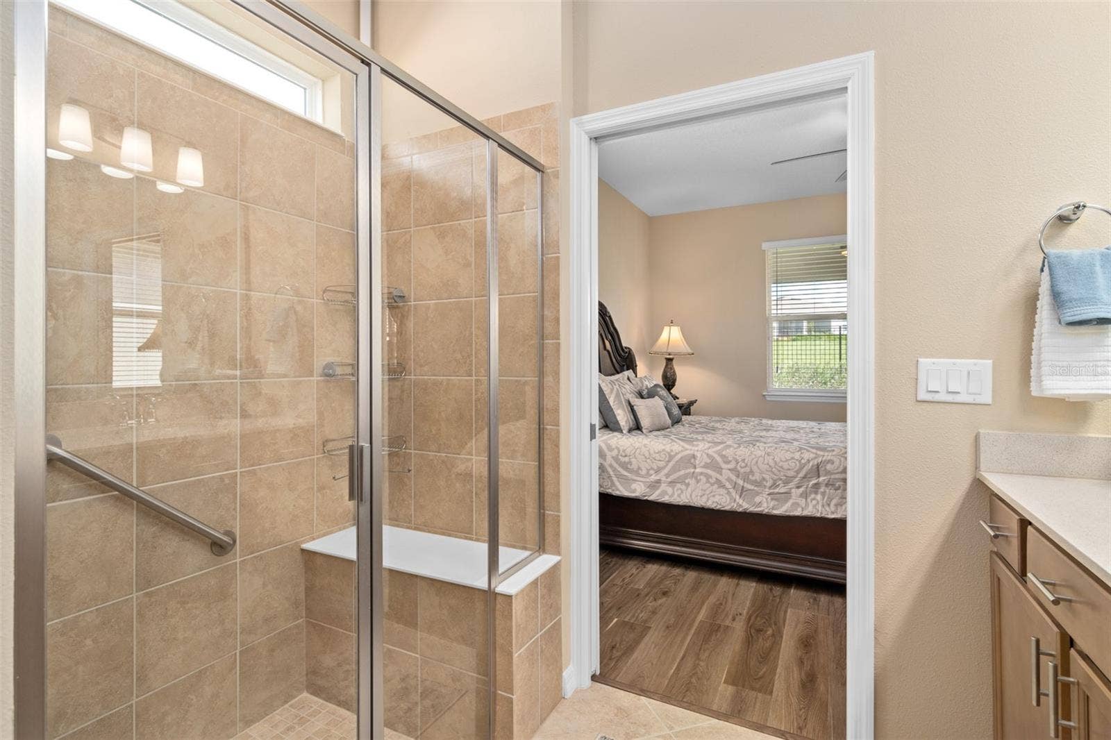 2759 PURPLE MEADOW COURT, Minneola, FL 34715 Primary Bedroom En-Suite Shower with Upgraded Wall tile and a Bench for your convenience