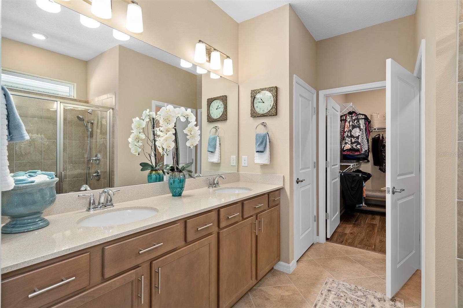 2759 PURPLE MEADOW COURT, Minneola, FL 34715 Primary Bedroom En-Suite with a Walk-in Closet, Linen Closet, Water Closet. The Comfort Height Vanity has a Quartz Countertop.