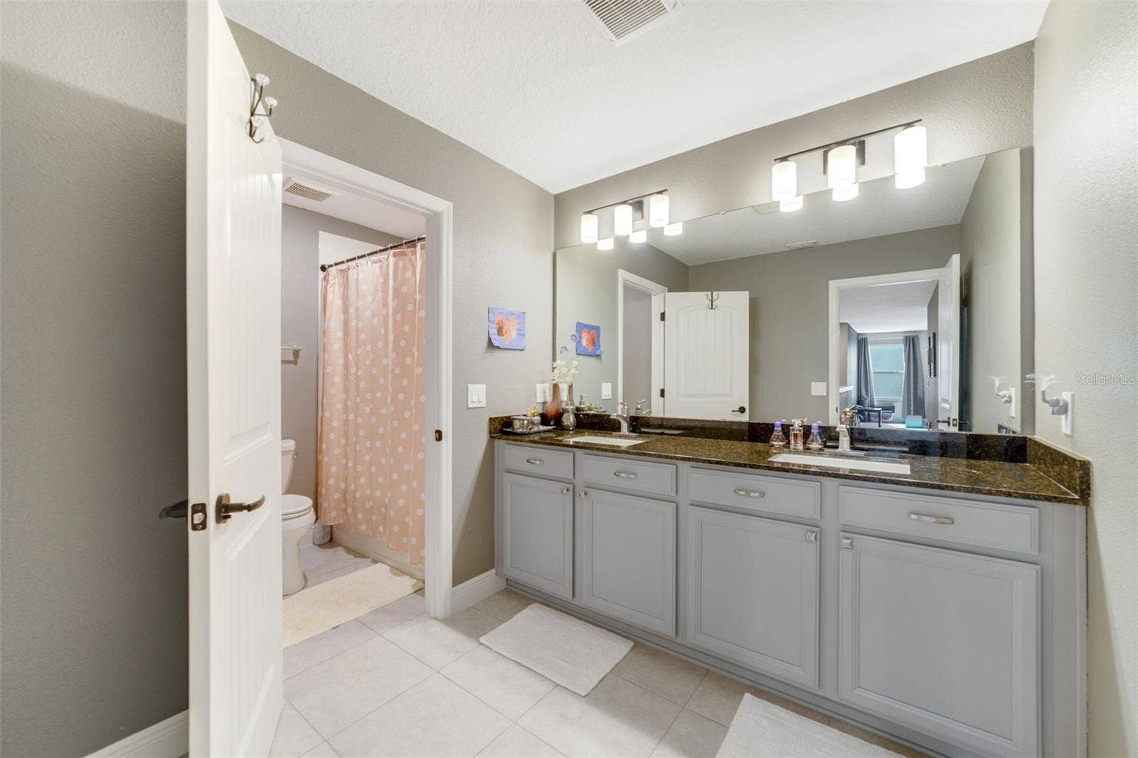 Three additional bedrooms and another full bath offer plenty of comfortable space for family and guests.