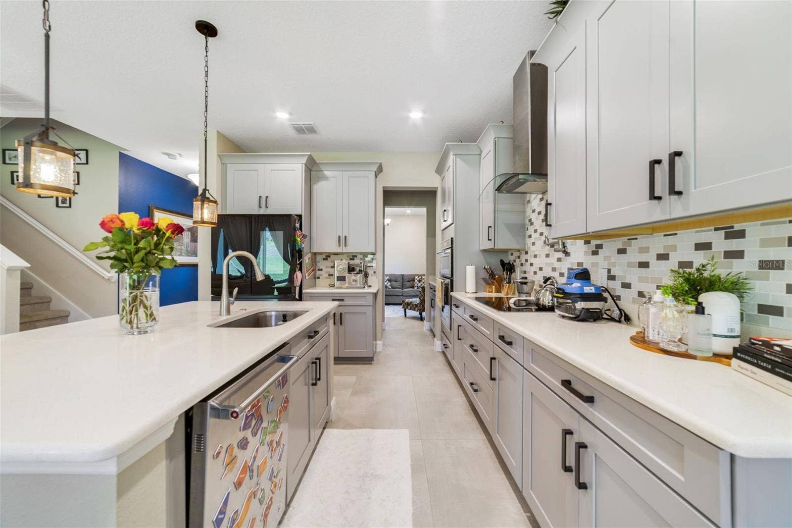 The open-concept Kitchen features abundant cabinet storage and expansive counters for meal prep.