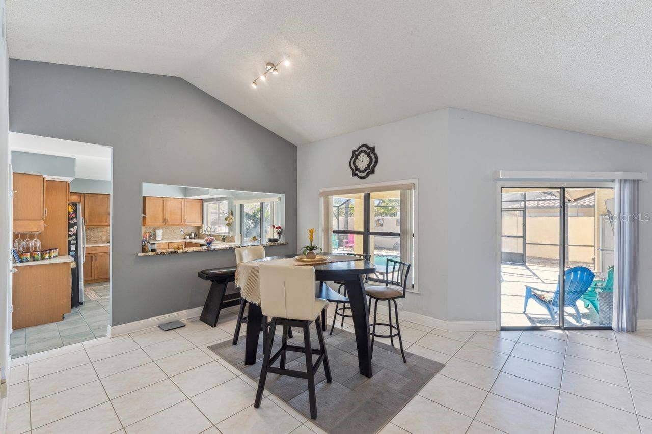 8215 ROLLA COURT, Orlando, FL 32836 View of dinette in great room with access to pool and kitchen