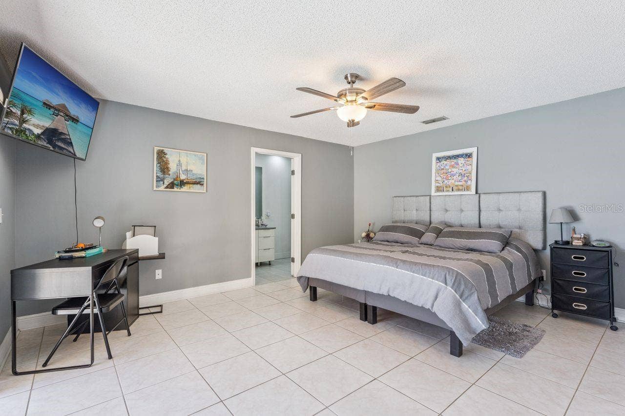 8215 ROLLA COURT, Orlando, FL 32836 Primary bedroom with view of pool