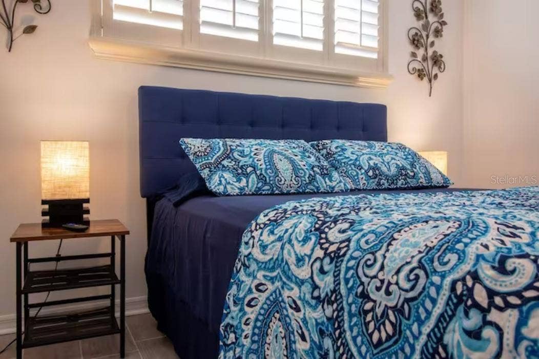3120 PEEL AVENUE, Orlando, FL 32806 Master with queen bed, side tables with lamps.