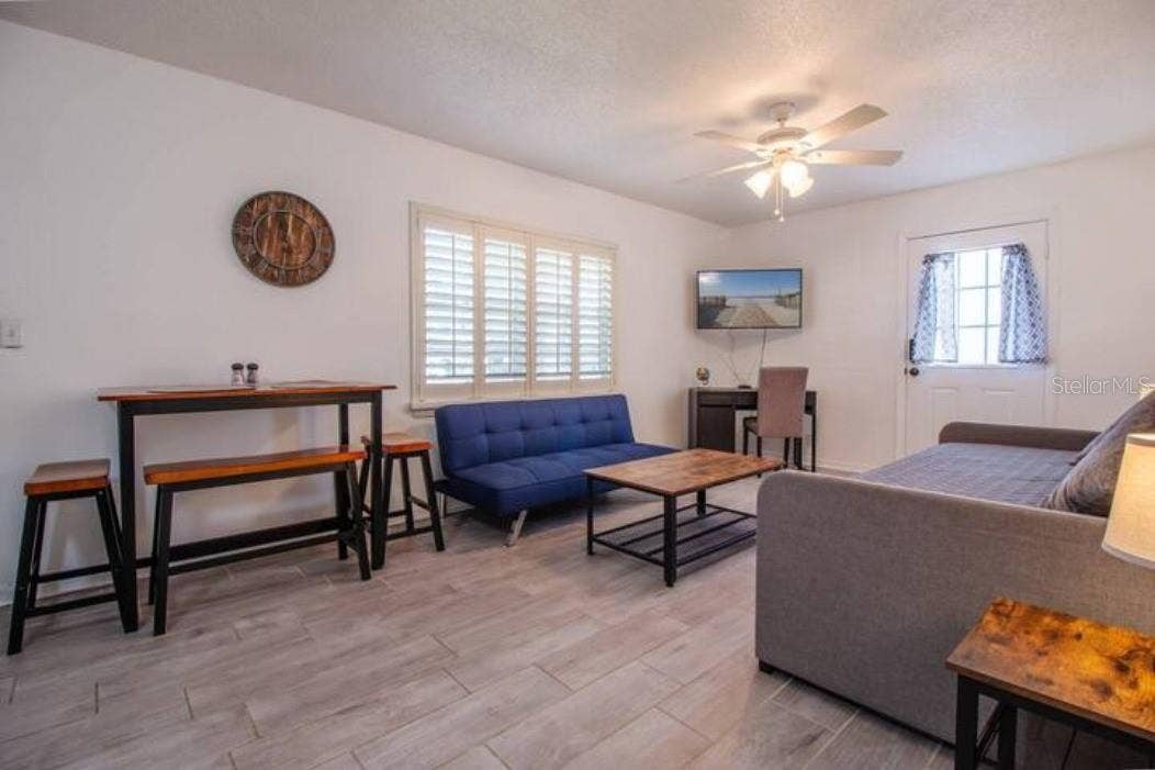 3120 PEEL AVENUE, Orlando, FL 32806 Shared living room with 2 sofa beds, dining table, tv, Laptop-friendly workspace
