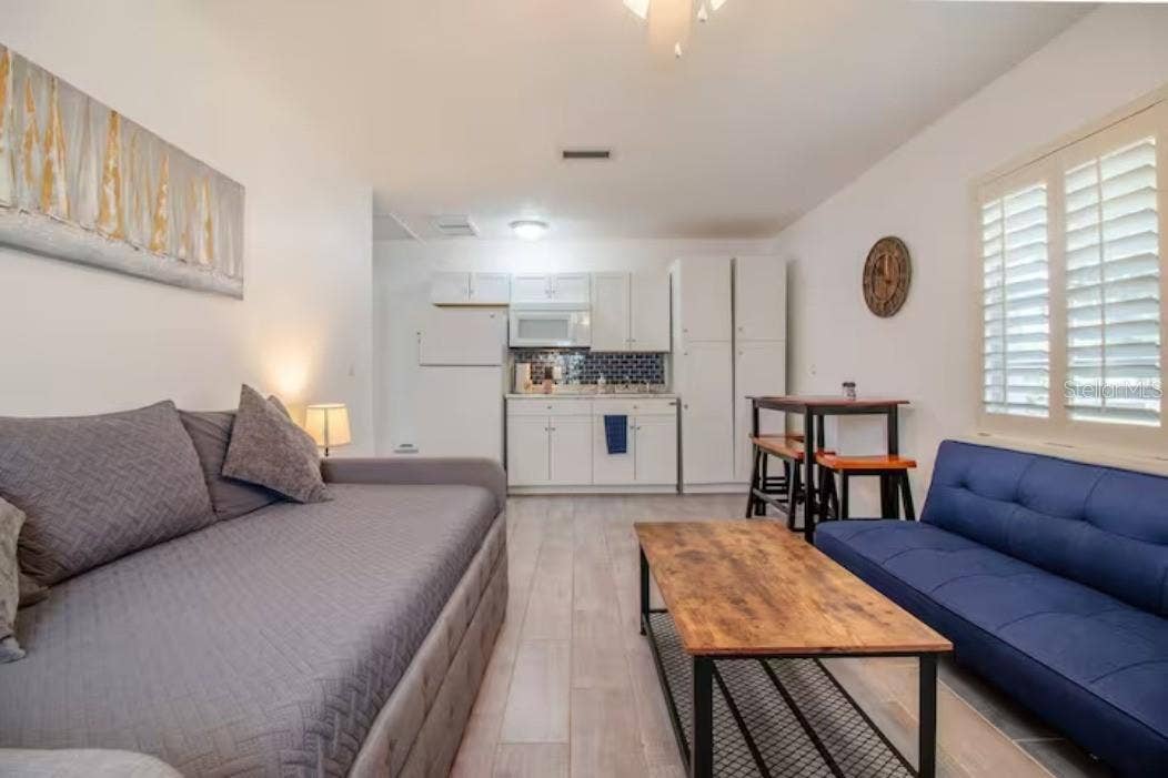 3120 PEEL AVENUE, Orlando, FL 32806 Shared living room with 2 sofa beds, dining table, kitchenette