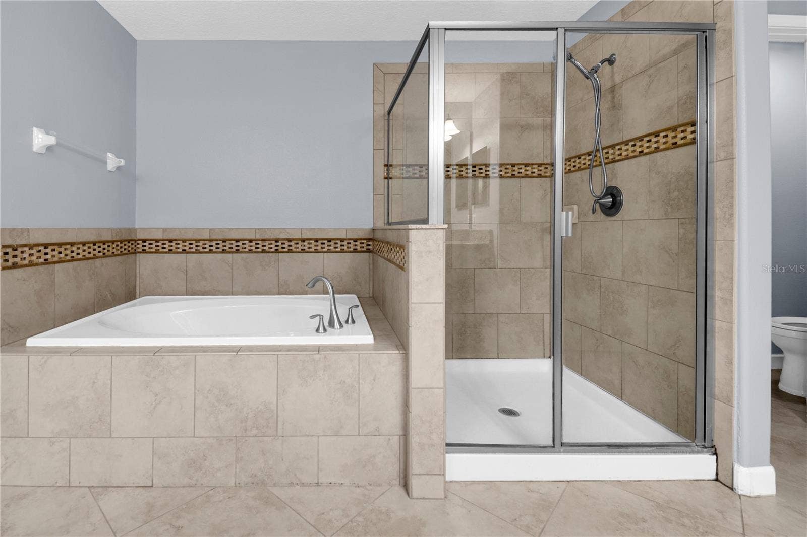 1301 GLENEAGLES LANE, Davenport, FL 33896 Upstairs Master Bathroom has a soaking tub and walk in shower