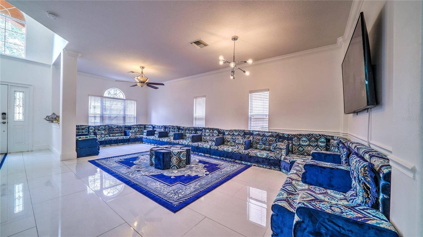 6956 LUCCA STREET, Orlando, FL 32819 This living room is bright, spacious, and designed for both comfort and entertaining.