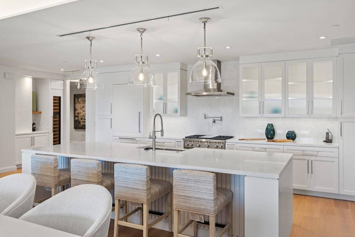 10160 AUTUMN MIST LANE, #402, Orlando, FL 32836 Custom frameless contemporary wood cabinetry with full-extension drawer glides, soft-close drawer and doors, complemented by under-cabinet lighting.