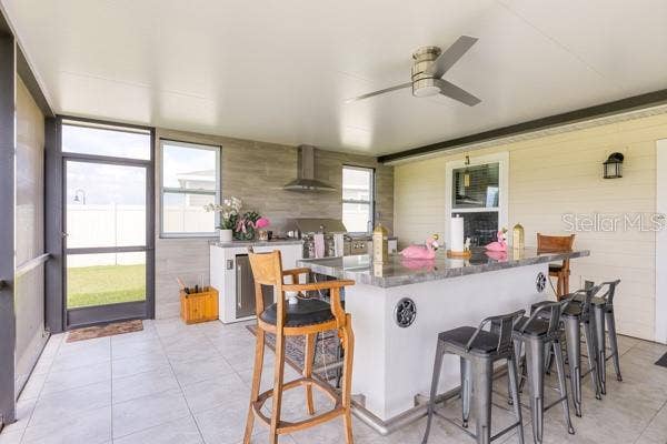 4382 FINCH LANE, Kissimmee, FL 34746 Dining and kitchen areas in lanai