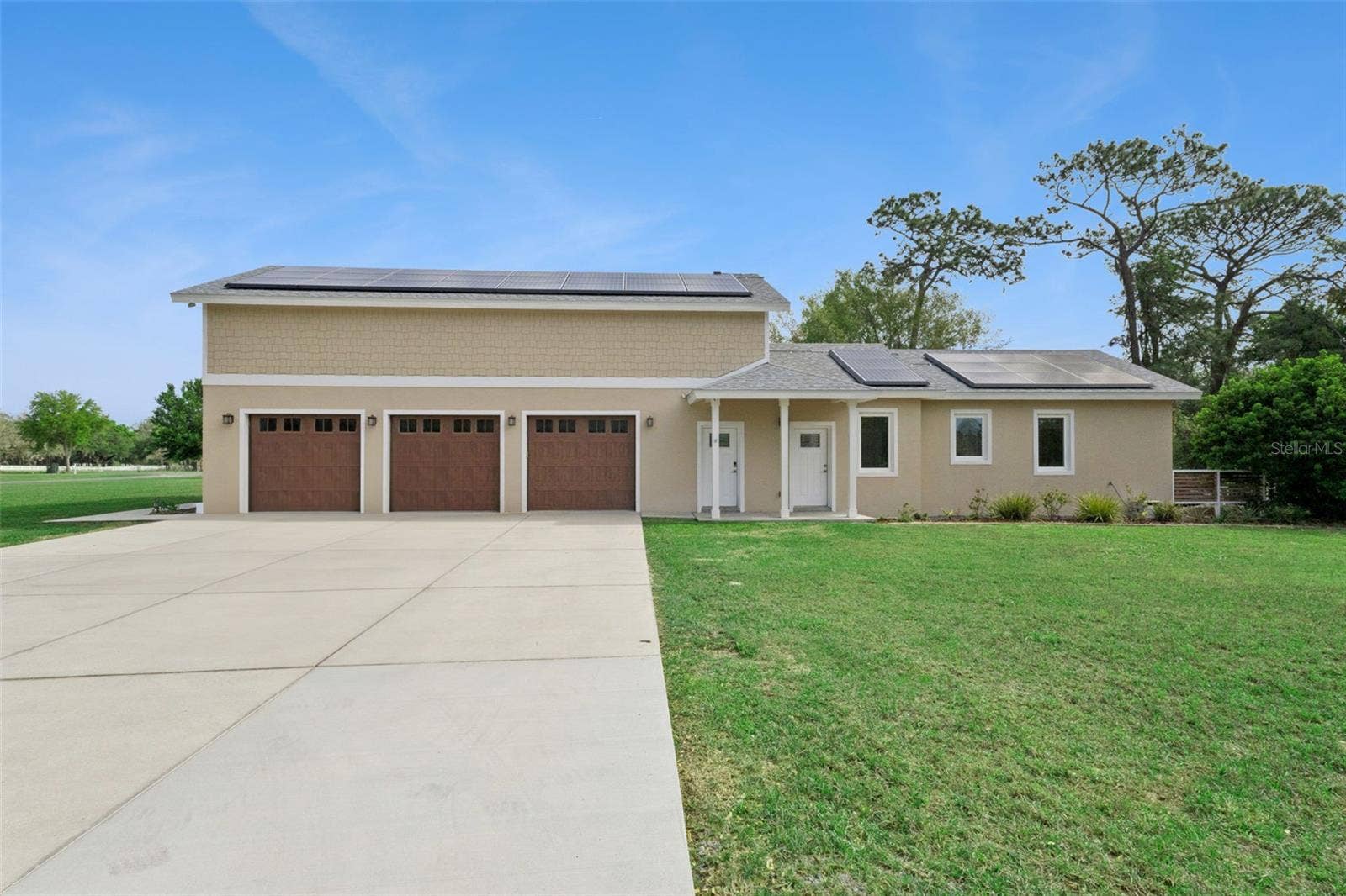 15503 TROTTING HORSE LANE, Tavares, FL 32778 Three car garage with plenty of parking and storage above the entire length of the garage