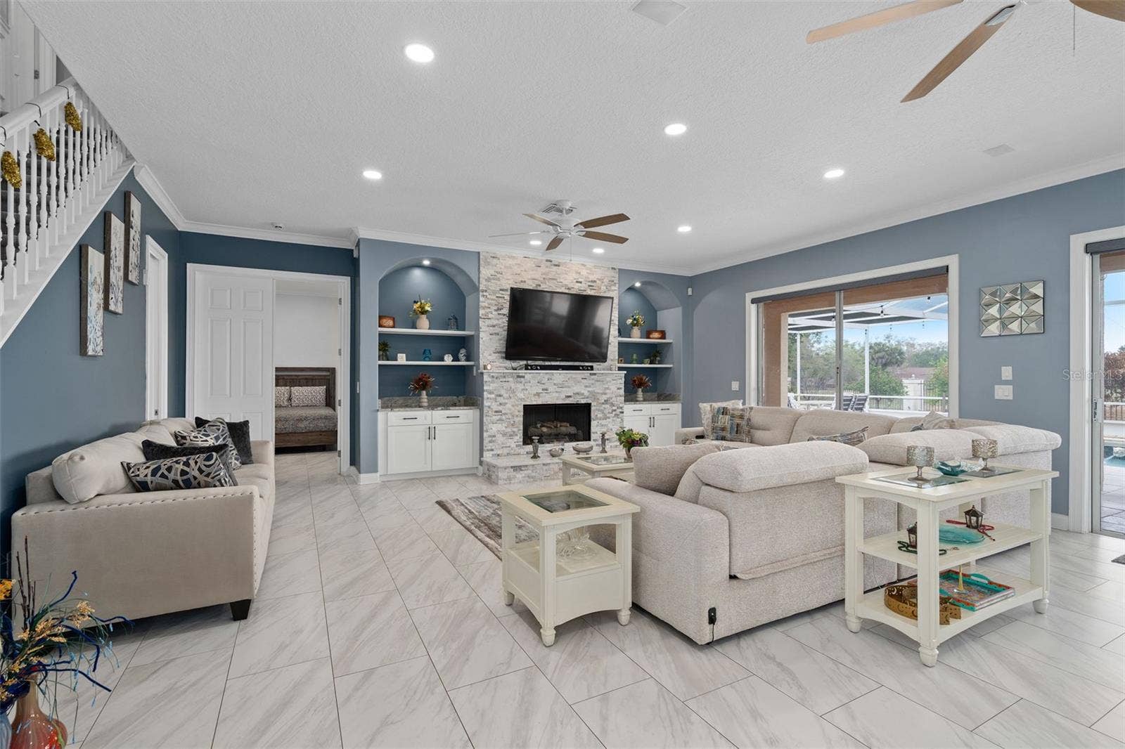 9057 BALMORAL MEWS SQUARE, Windermere, FL 34786 Family Room with custom stone fireplace, tile throughout the main floor, this whole home has been completely remodeled to perfection.