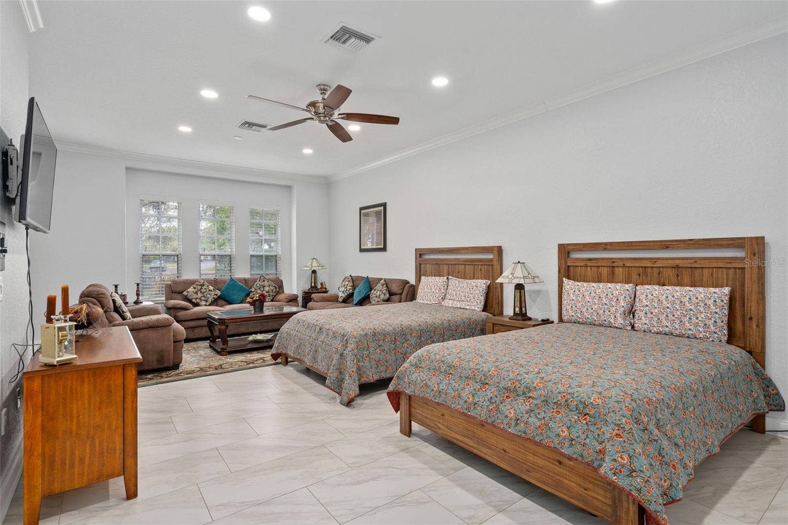 9057 BALMORAL MEWS SQUARE, Windermere, FL 34786 Downstairs Primary Bedroom with large sitting area. Has a door leading outside so could be used as an in law suite as well.