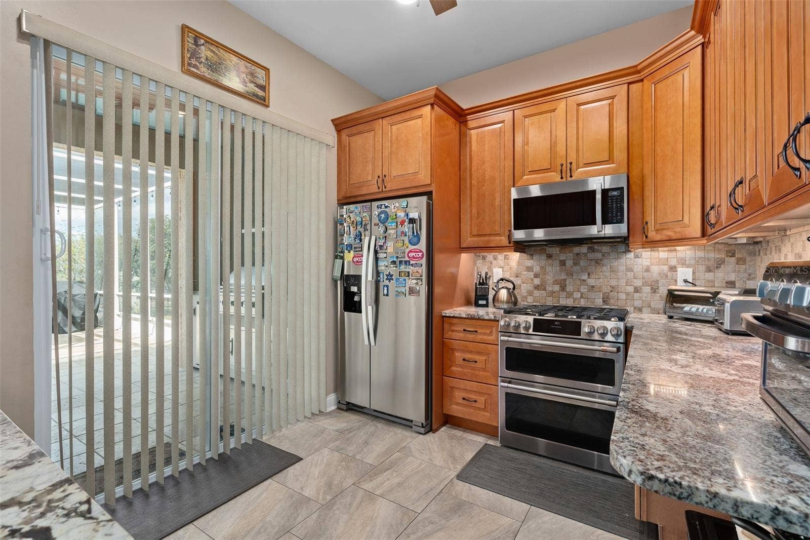 9057 BALMORAL MEWS SQUARE, Windermere, FL 34786 Second Kitchen has a sliding door to the rear lanai and also a door leading directly into the home.