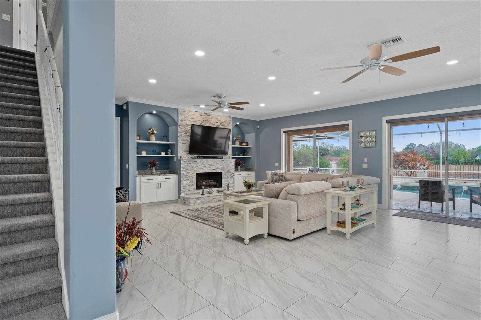 9057 BALMORAL MEWS SQUARE, Windermere, FL 34786 Family Room with custom drawers built into the wall mirroring both sides of the fireplace.