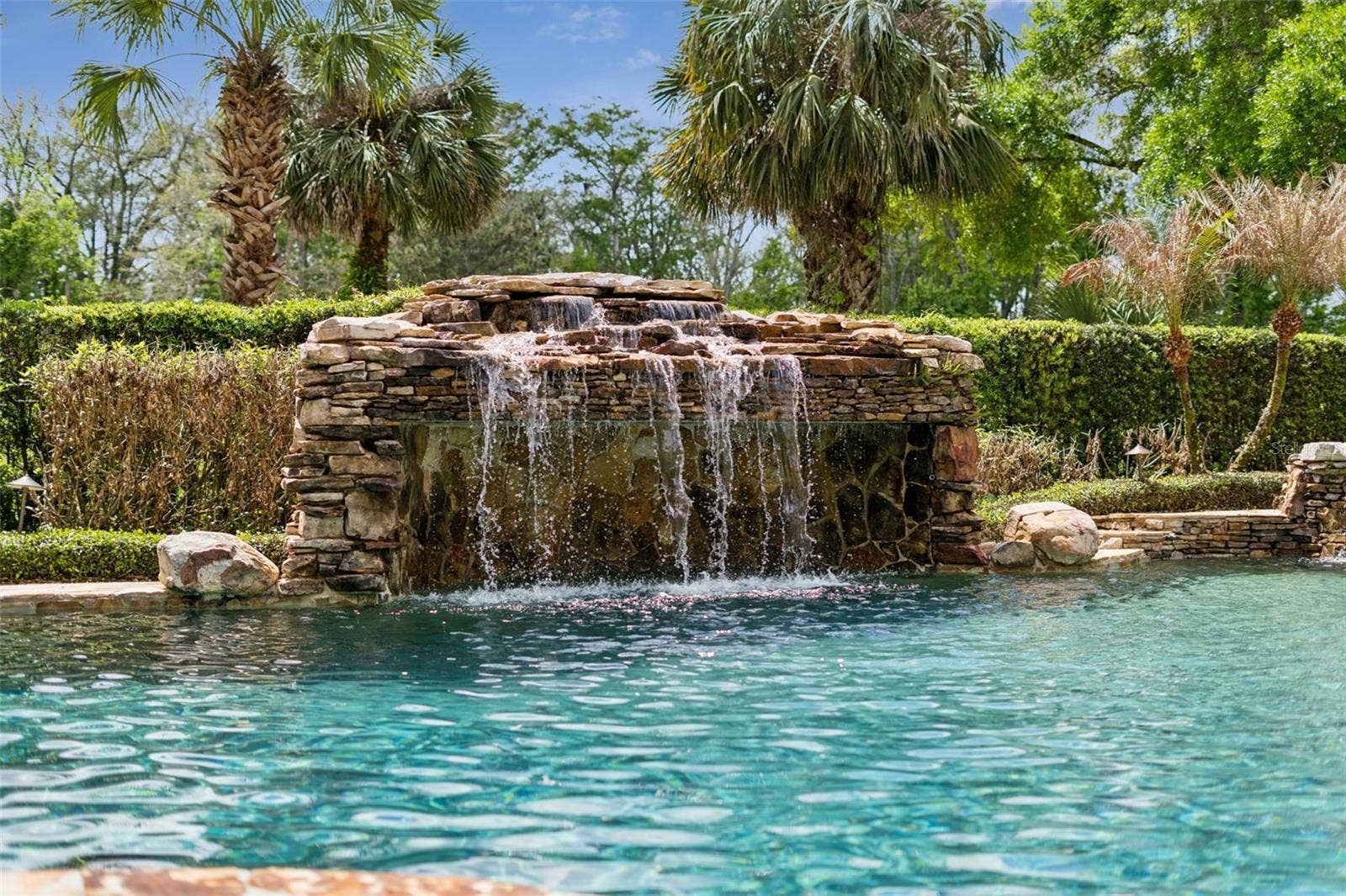 3545 LEGACY HILLS COURT, Longwood, FL 32779 Waterfall with a grotto and built-in bench