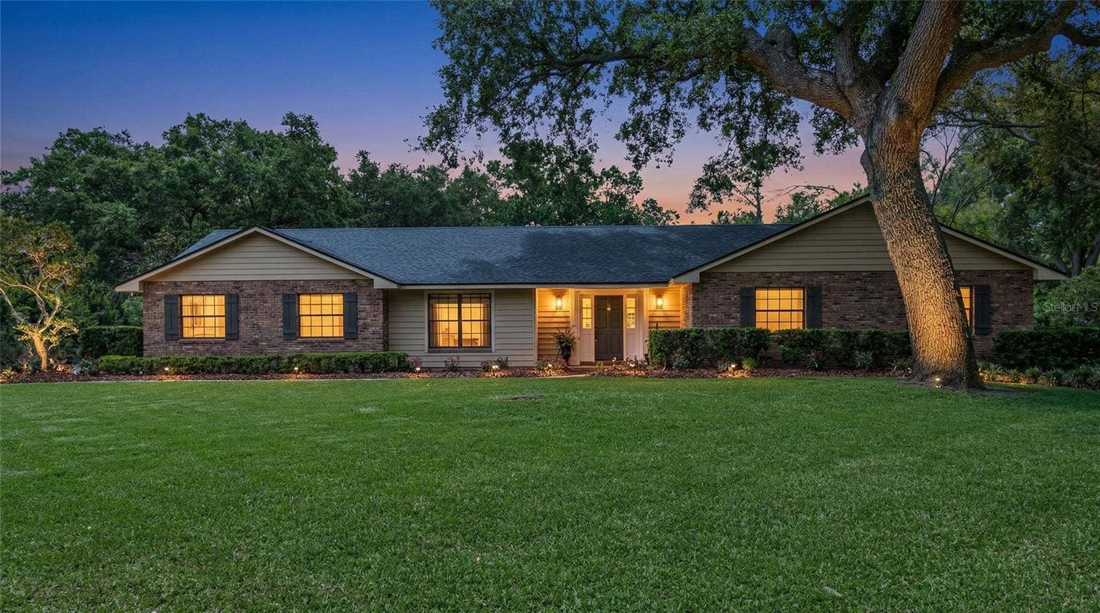 14140 COUNTRY ESTATE DRIVE, Winter Garden, FL 34787 Welcome home to peaceful evenings and classic charm, with mature trees, inviting lighting, and exceptional curb appeal on a generously sized homesite.