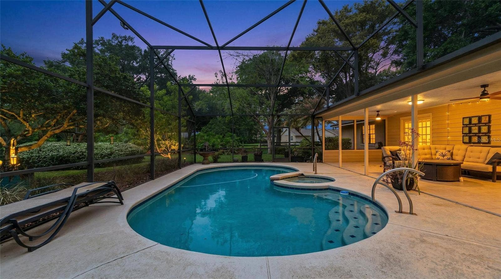 14140 COUNTRY ESTATE DRIVE, Winter Garden, FL 34787 Breathtaking resort-style pool and spa within a screened enclosure, complemented by a covered outdoor living area--designed for elegant entertaining and serene evenings.