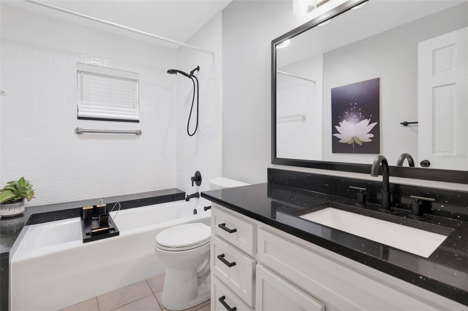 14140 COUNTRY ESTATE DRIVE, Winter Garden, FL 34787 Elegantly updated bath showcasing granite countertops, designer fixtures, and a refined, spa-like ambiance.