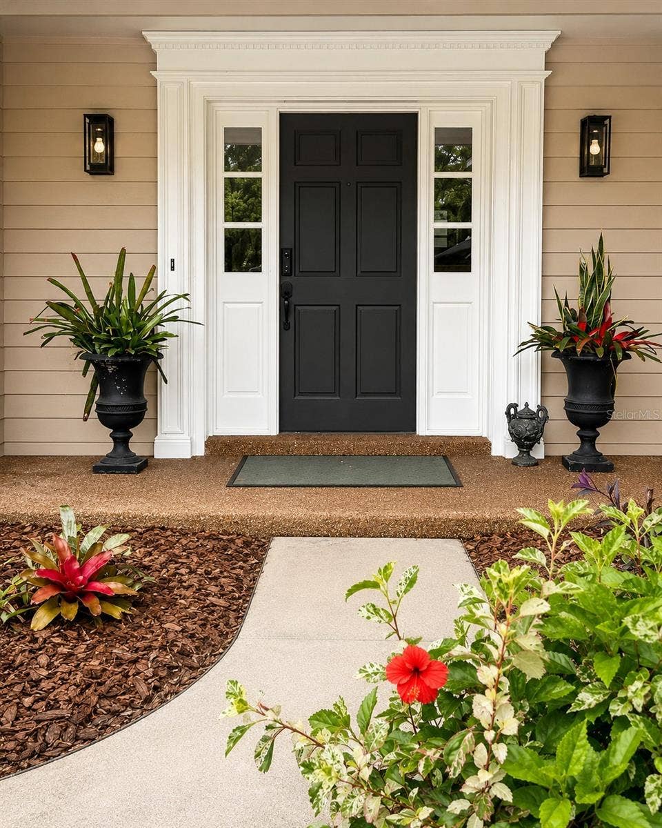 14140 COUNTRY ESTATE DRIVE, Winter Garden, FL 34787 Grand, inviting entry highlighted by detailed millwork, designer lighting, and a striking front door- an elegant introduction to the home.