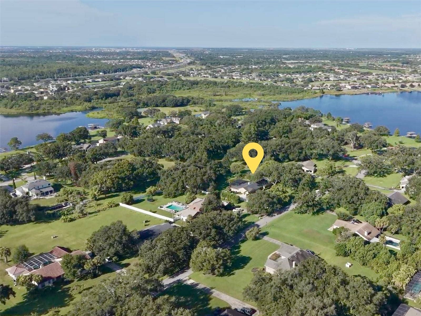 14140 COUNTRY ESTATE DRIVE, Winter Garden, FL 34787 Beautiful 1+ acre lot. Home and property noted with yellow marker. Lake Tilden can bee seen in background on left, and Black Lake is in the background on the right. The community amenity center is located on a peninsula between these two lakes, giving access to both with a private community boat ramp. Residents also enjoy tennis courts and a large picnic pavilion also located at this spot.