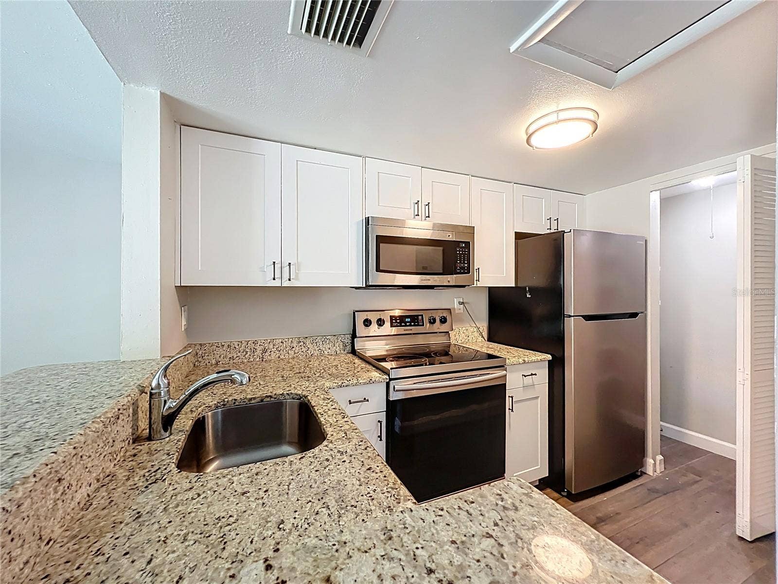 590 ORANGE DRIVE, #136, Altamonte Springs, FL 32701 Kitchen with Granite Counter Top and Stainless Steel Appliances