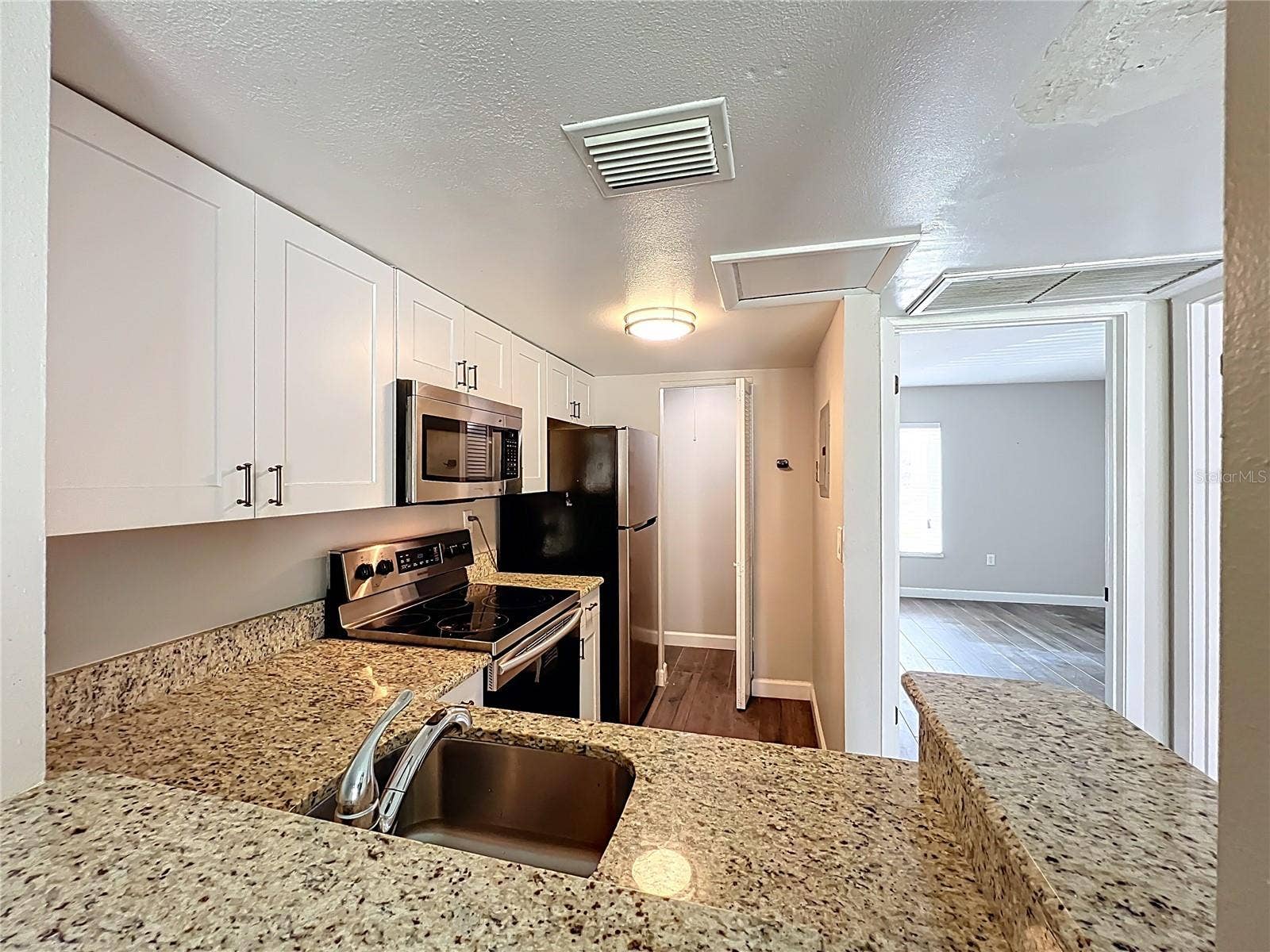 590 ORANGE DRIVE, #136, Altamonte Springs, FL 32701 Kitchen with Granite Counter Top and Stainless Steel Appliances