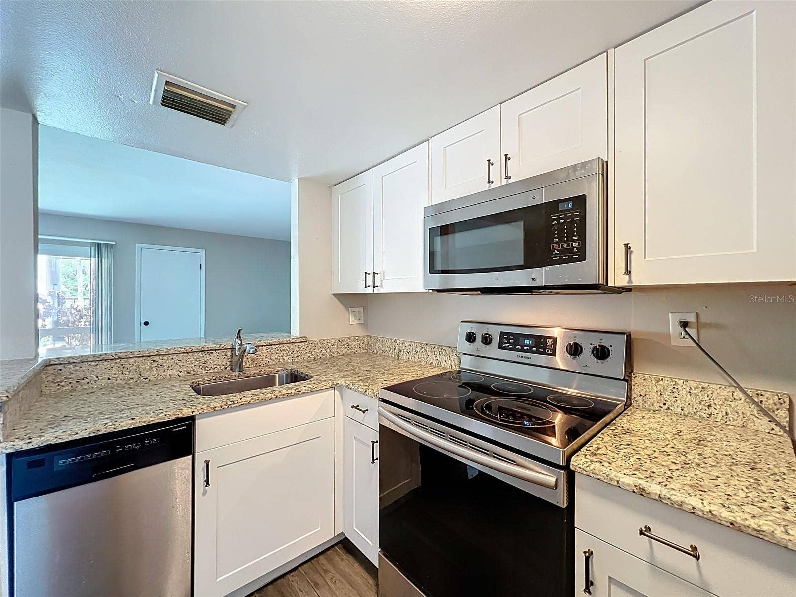 590 ORANGE DRIVE, #136, Altamonte Springs, FL 32701 Kitchen with Granite Counter Top and Stainless Steel Appliances