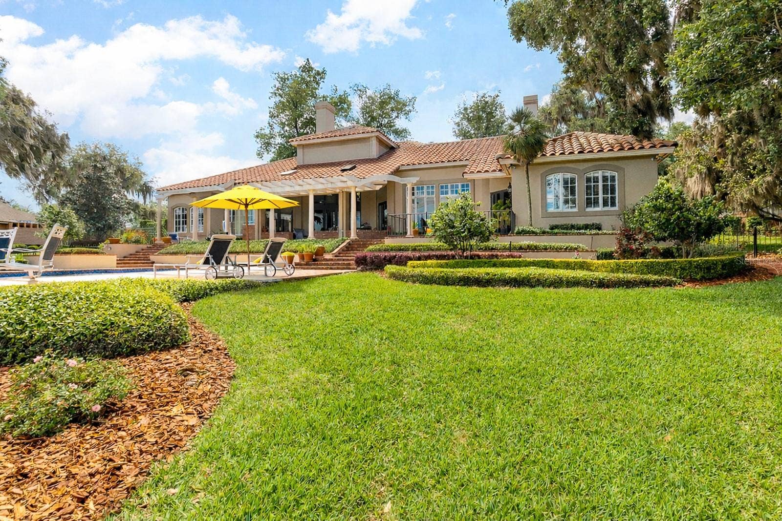 1351 N CLASSIC COURT, Longwood, FL 32779 Experience your LAKESIDE LEGACY with 4-5 bedrooms, 5.5 baths pool home, three-car garage, porte-cochere, pool and spa, boathouse and dock, plus bonus flex space in the basementideal for a workout room or wine tasting cellar.