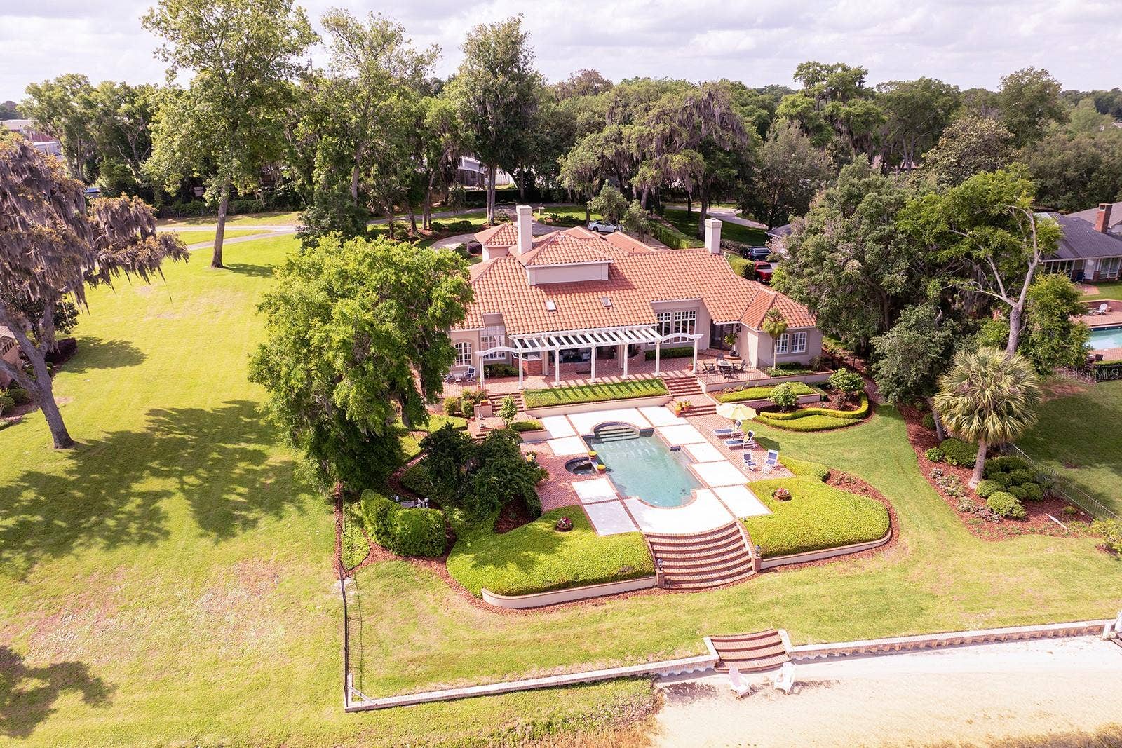 1351 N CLASSIC COURT, Longwood, FL 32779 firm. Every detail reflects elegance and grace for the most discerning homeowner. The cultivated beauty of this one-owner home is nestled on a lush, private enclave, occupying an oversized four-acre lot with **1 + acre dedicated to the residence itself.