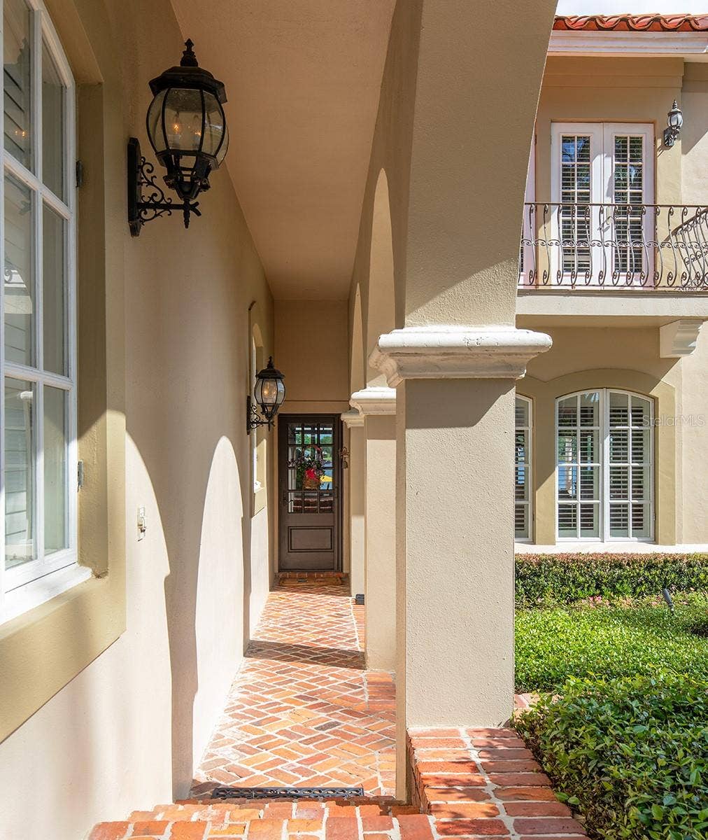 1351 N CLASSIC COURT, Longwood, FL 32779 Covered walkway from the Porte -Cochere directly into another entrance to the home.