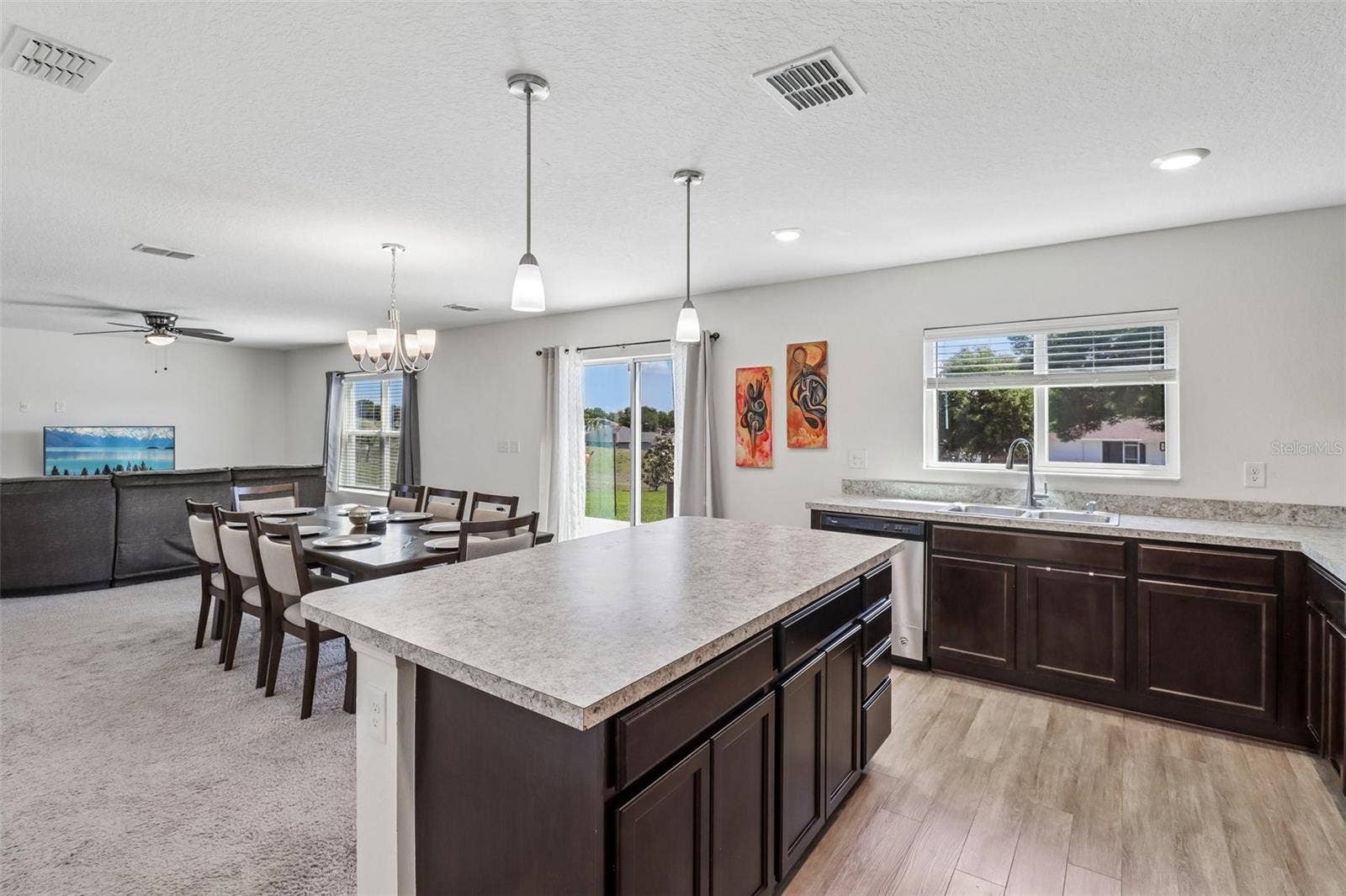 Kitchen is open to the dining and living areas.