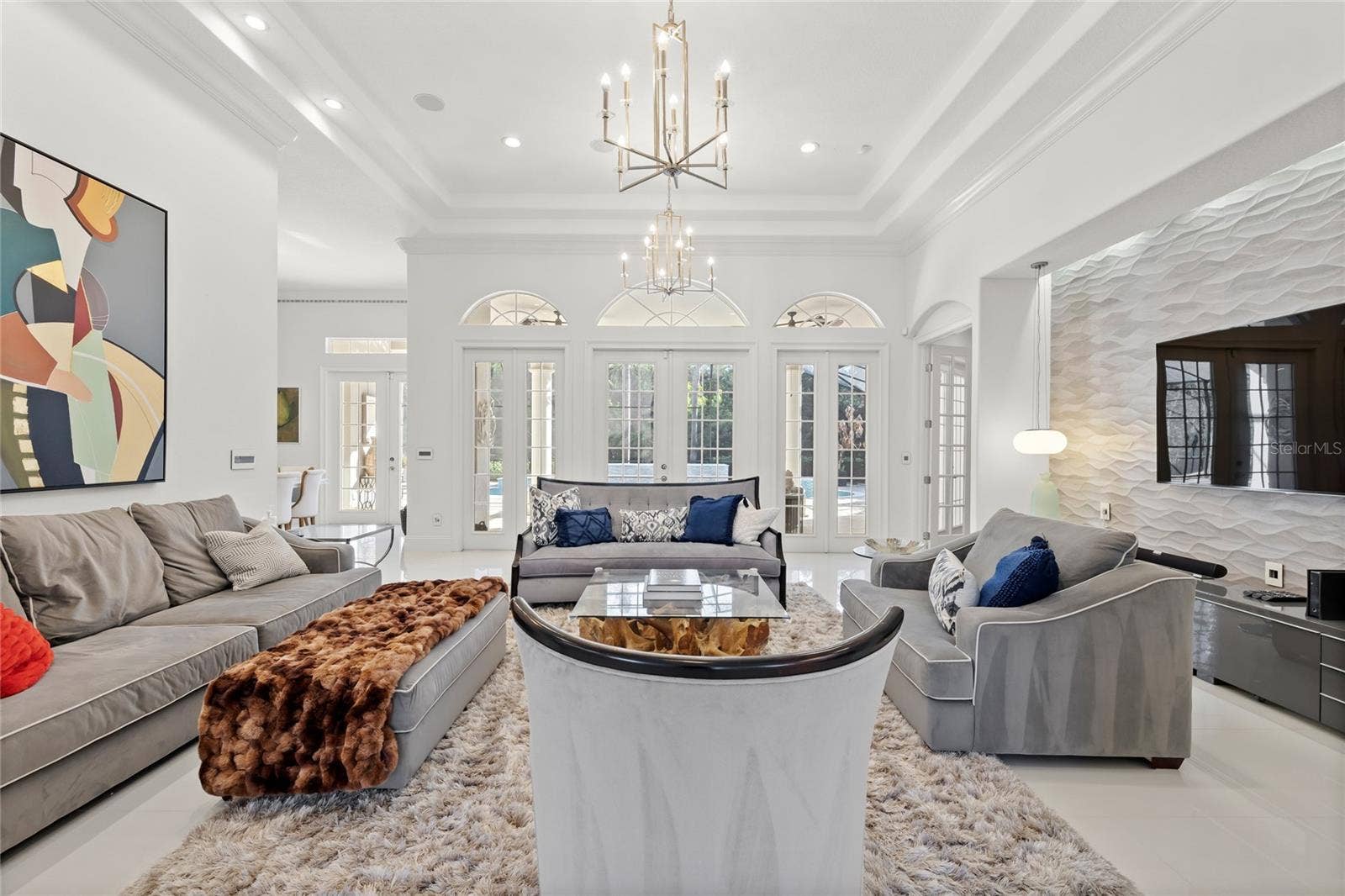 11051 HAWKSHEAD COURT, Windermere, FL 34786 Family room opens to rear patio and pool. Primary suite off right hall and kitchen to the left