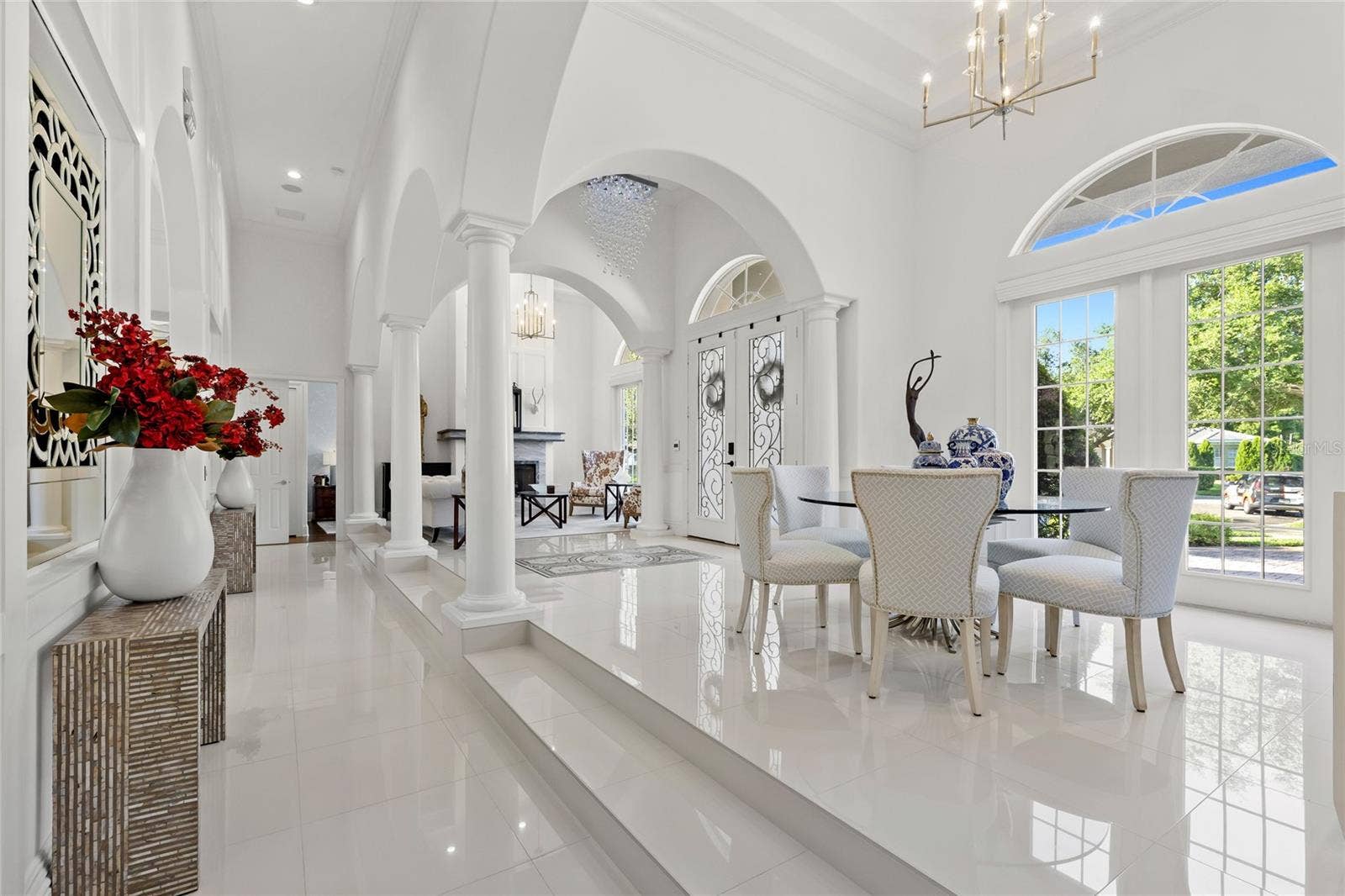 11051 HAWKSHEAD COURT, Windermere, FL 34786 View from hall to Bed 3 & 4 across Formal Dining, Entry & Formal Living into hall for Bed 5. Gorgeous soaring ceilings, updated fixtures and an abundance of light.