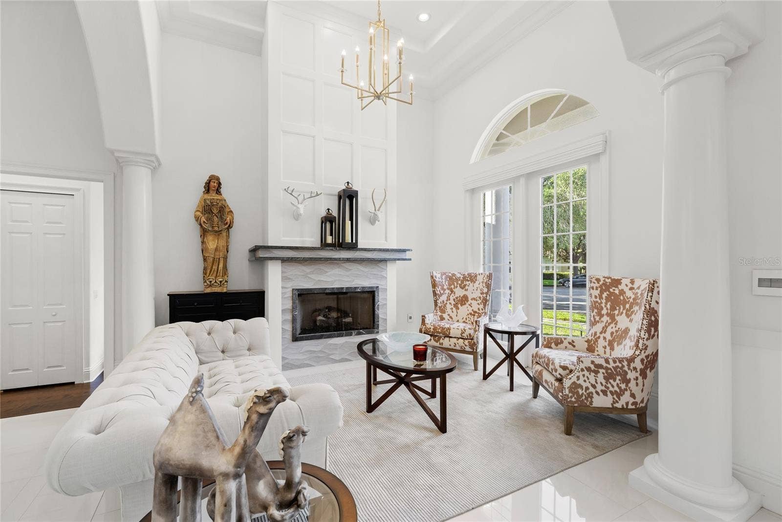 11051 HAWKSHEAD COURT, Windermere, FL 34786 Formal living space with gas fireplace. Access to hall bath and Bed 5 with en suite