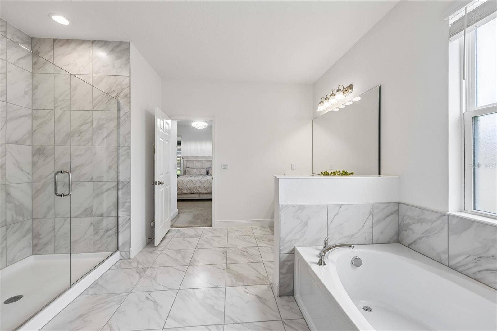 Upgraded en-suite bath includes a soaking tub and separate glass enclosed shower.