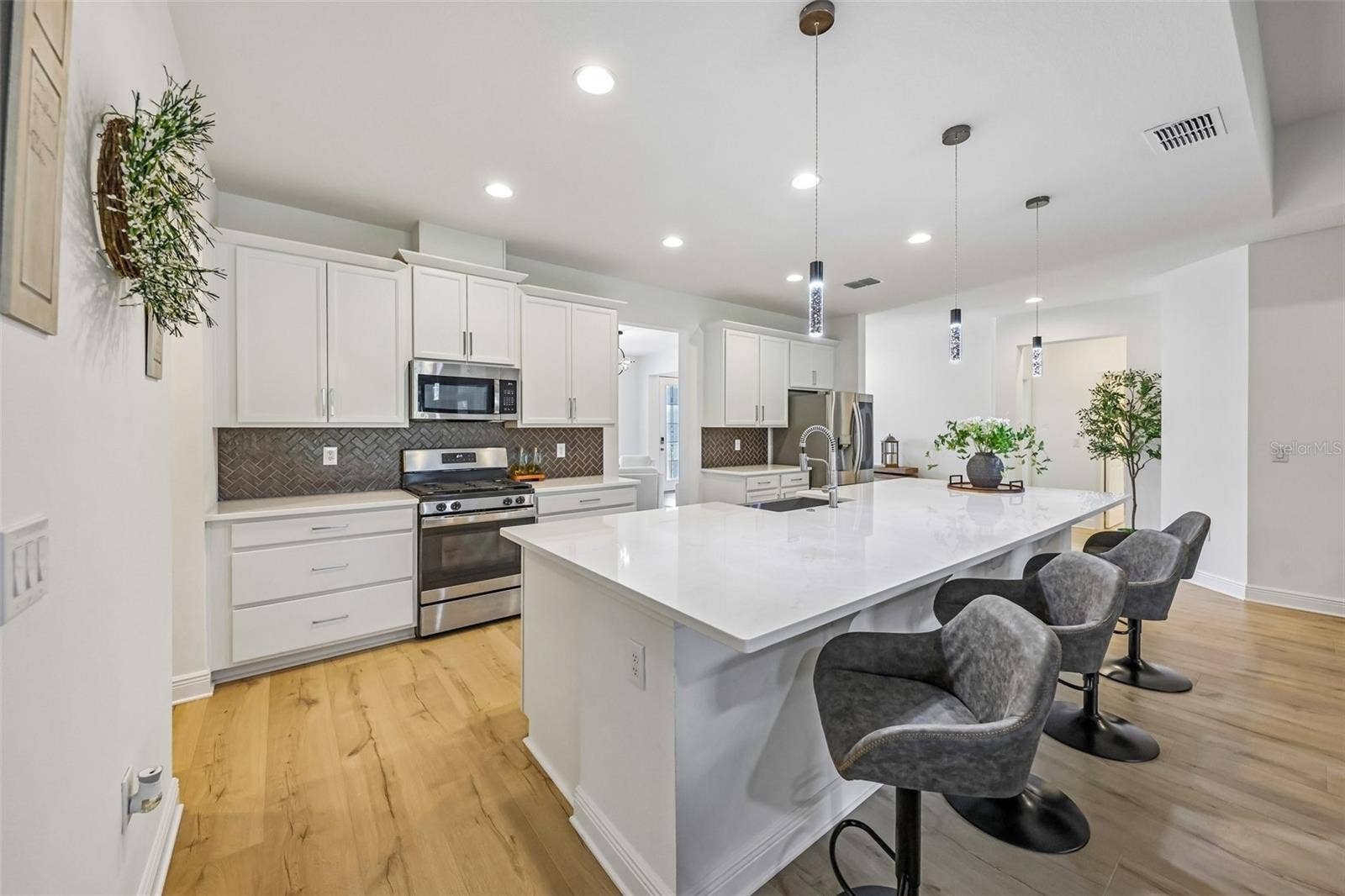 Not to be outdone, the interior delivers a bright, flowing layout anchored by a CHEFS GOURMET KITCHEN that truly serves as the heart of the home.