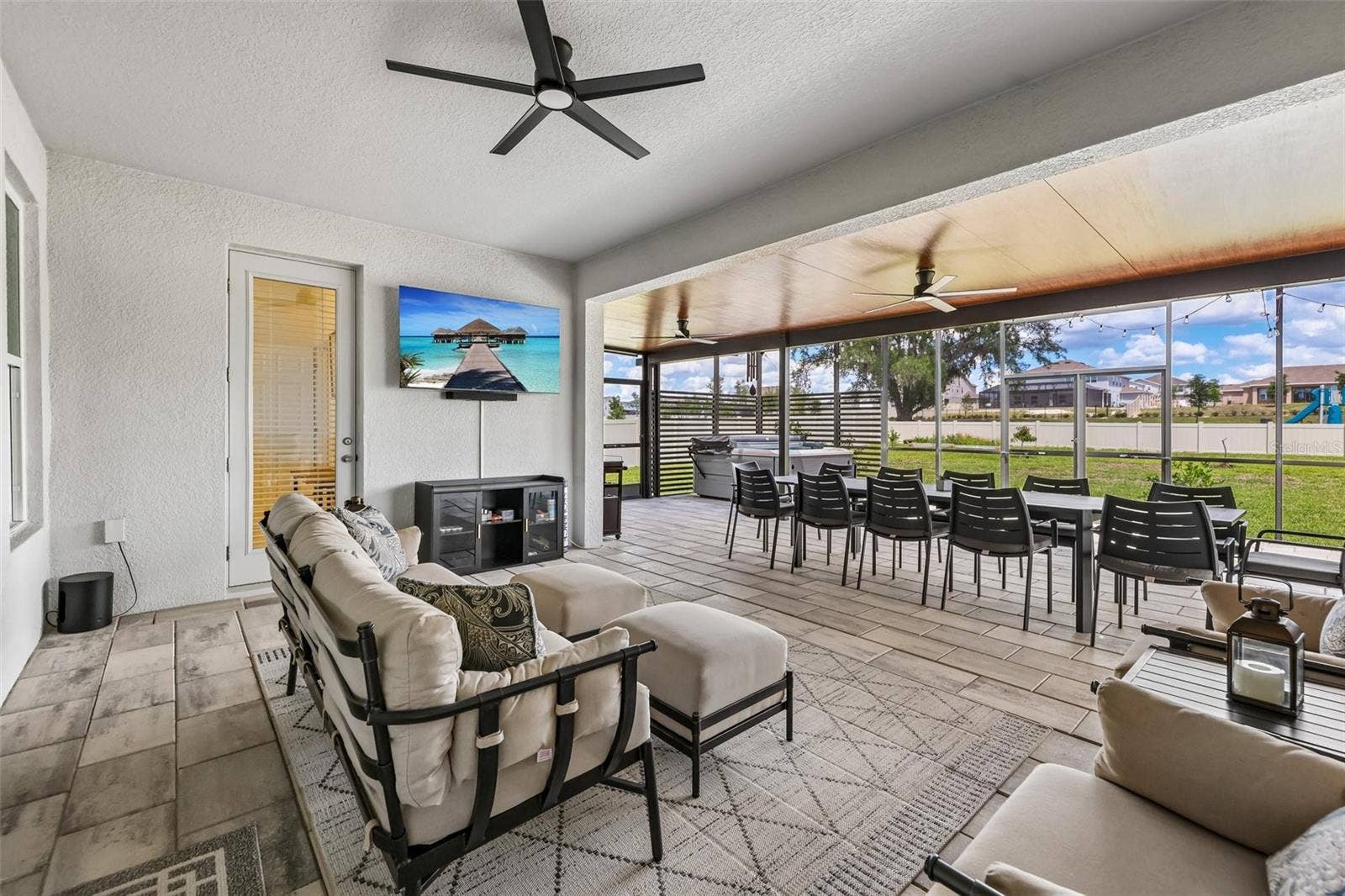 The covered lanai has been extended to create an outdoor oasis with multiple seating areas.