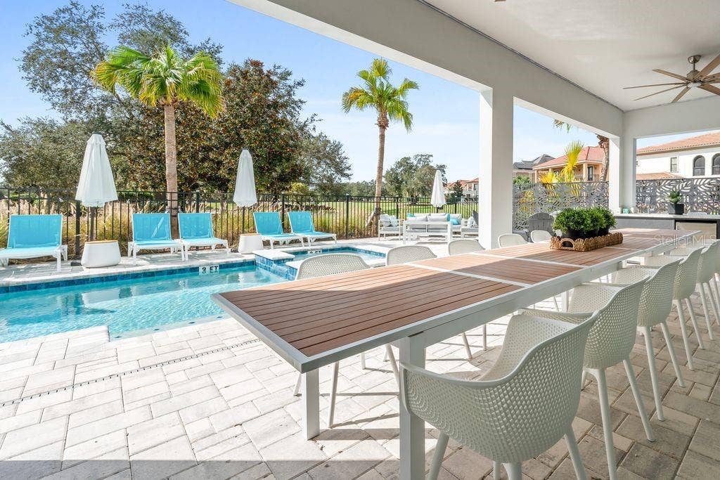 7442 GATHERING COURT, Kissimmee, FL 34747 Covered Lanai over table view