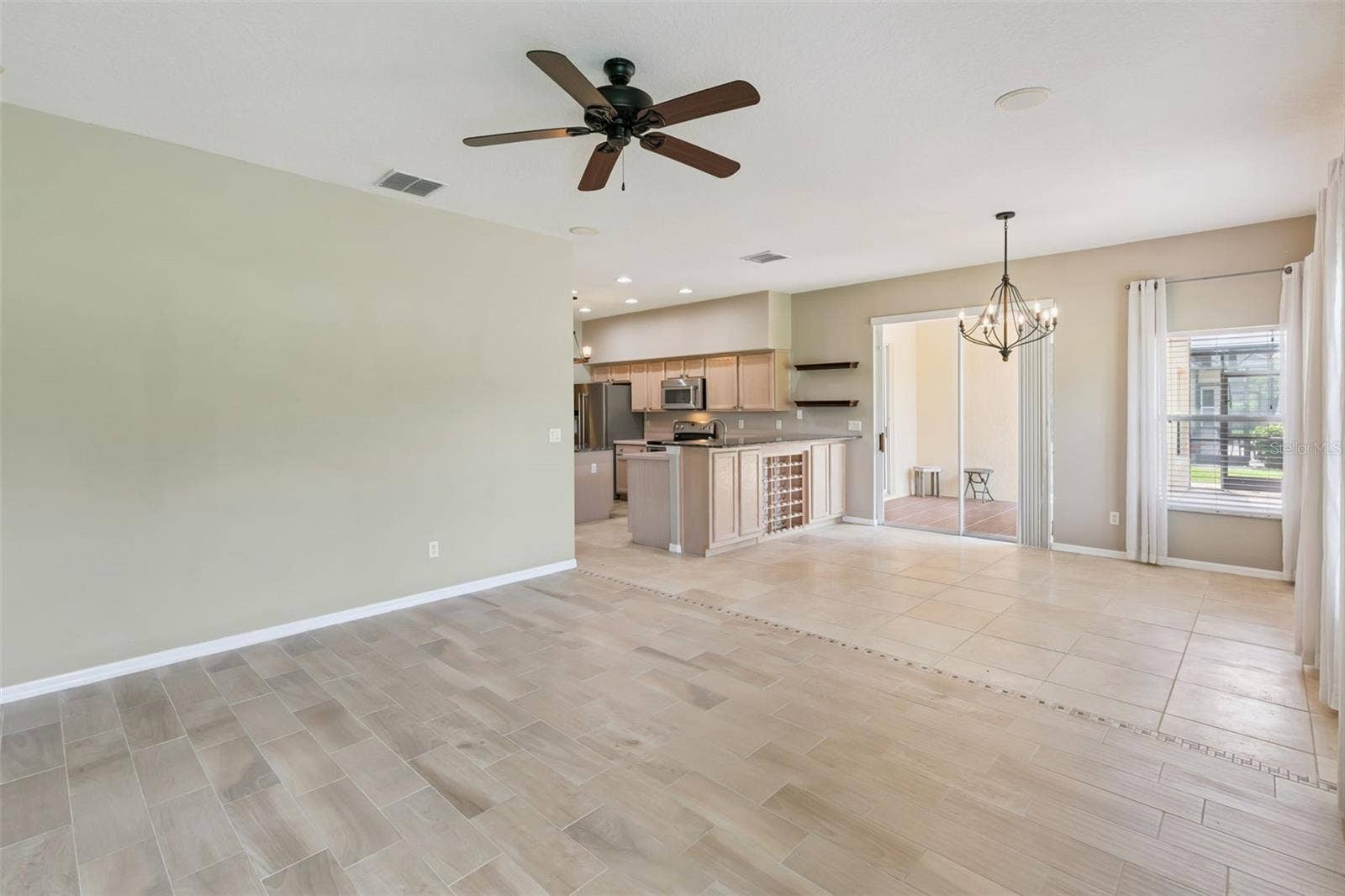 237 STRATHMORE CIRCLE, Kissimmee, FL 34744 Kitchen area leads out to screened patio.