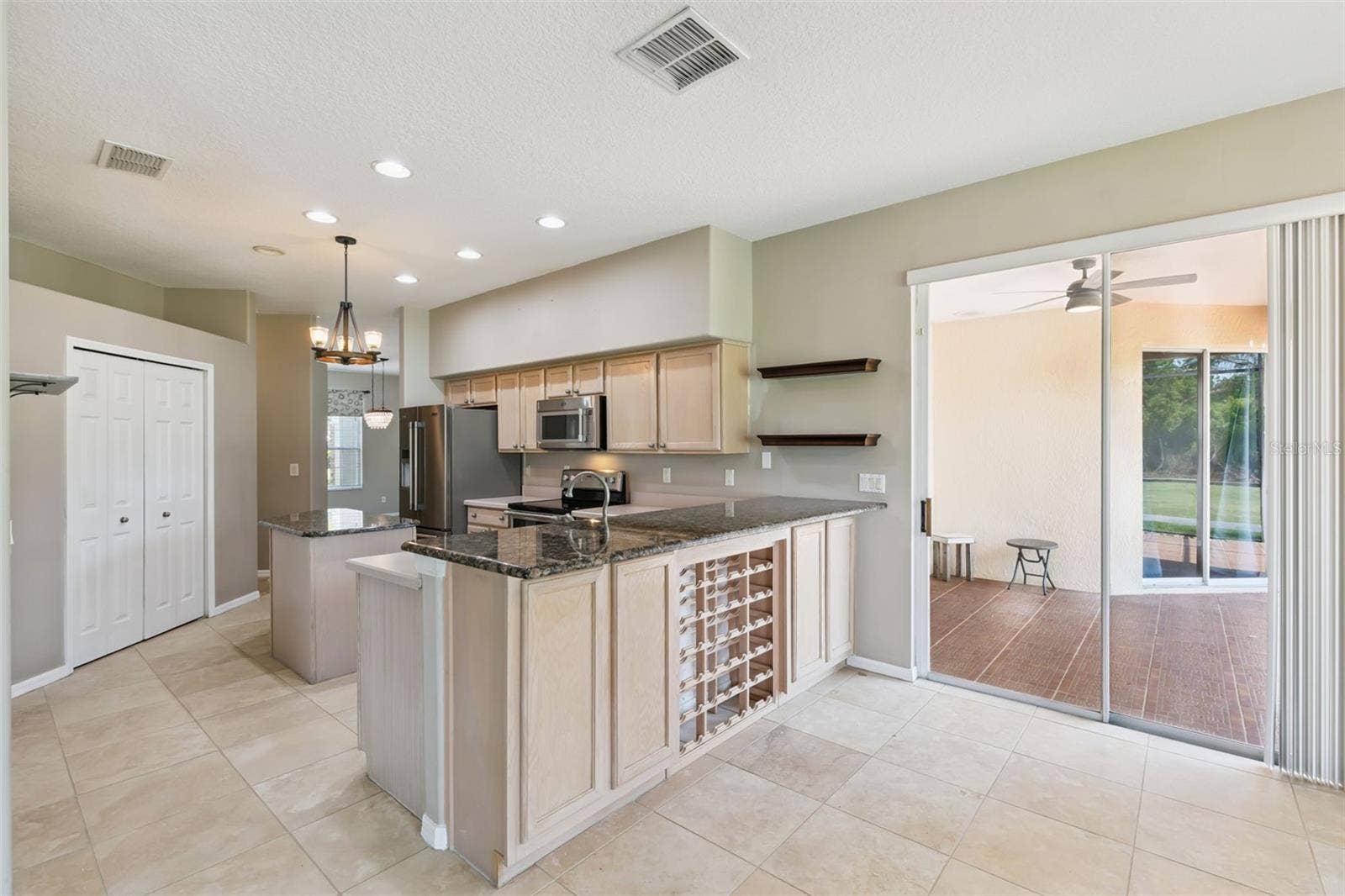 237 STRATHMORE CIRCLE, Kissimmee, FL 34744 Built-in wine rack and room for bar seating.