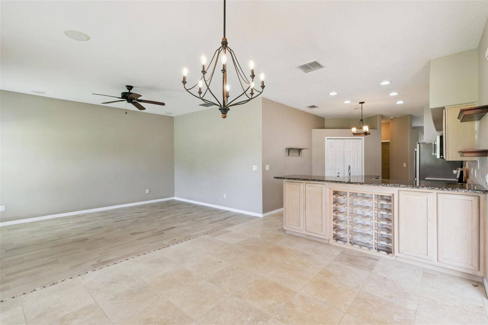 237 STRATHMORE CIRCLE, Kissimmee, FL 34744 Living room joined with kitchen and extra space.