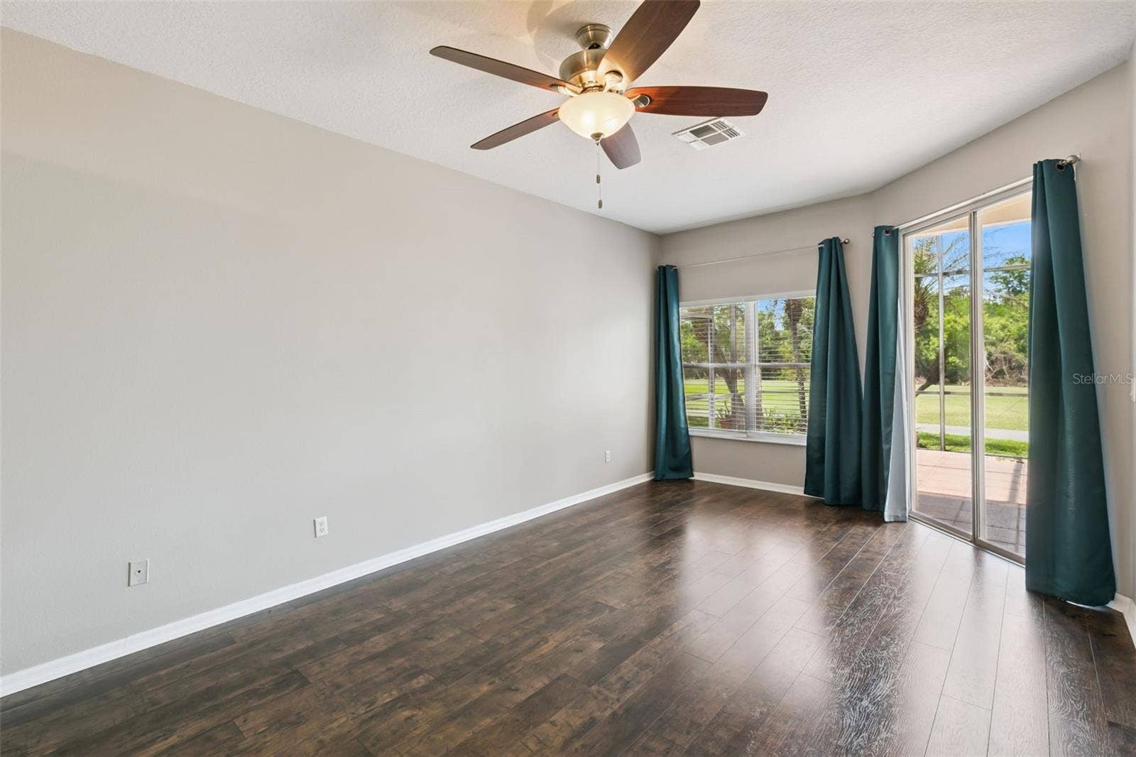 237 STRATHMORE CIRCLE, Kissimmee, FL 34744 Primary bedroom with entrance to screened patio.